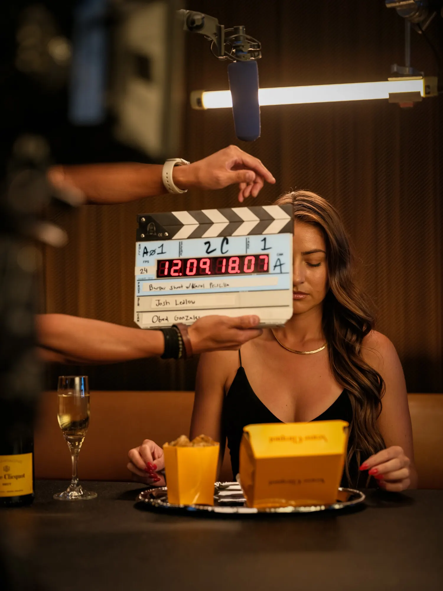 Behind the scenes on a food shoot, slate in front of camera