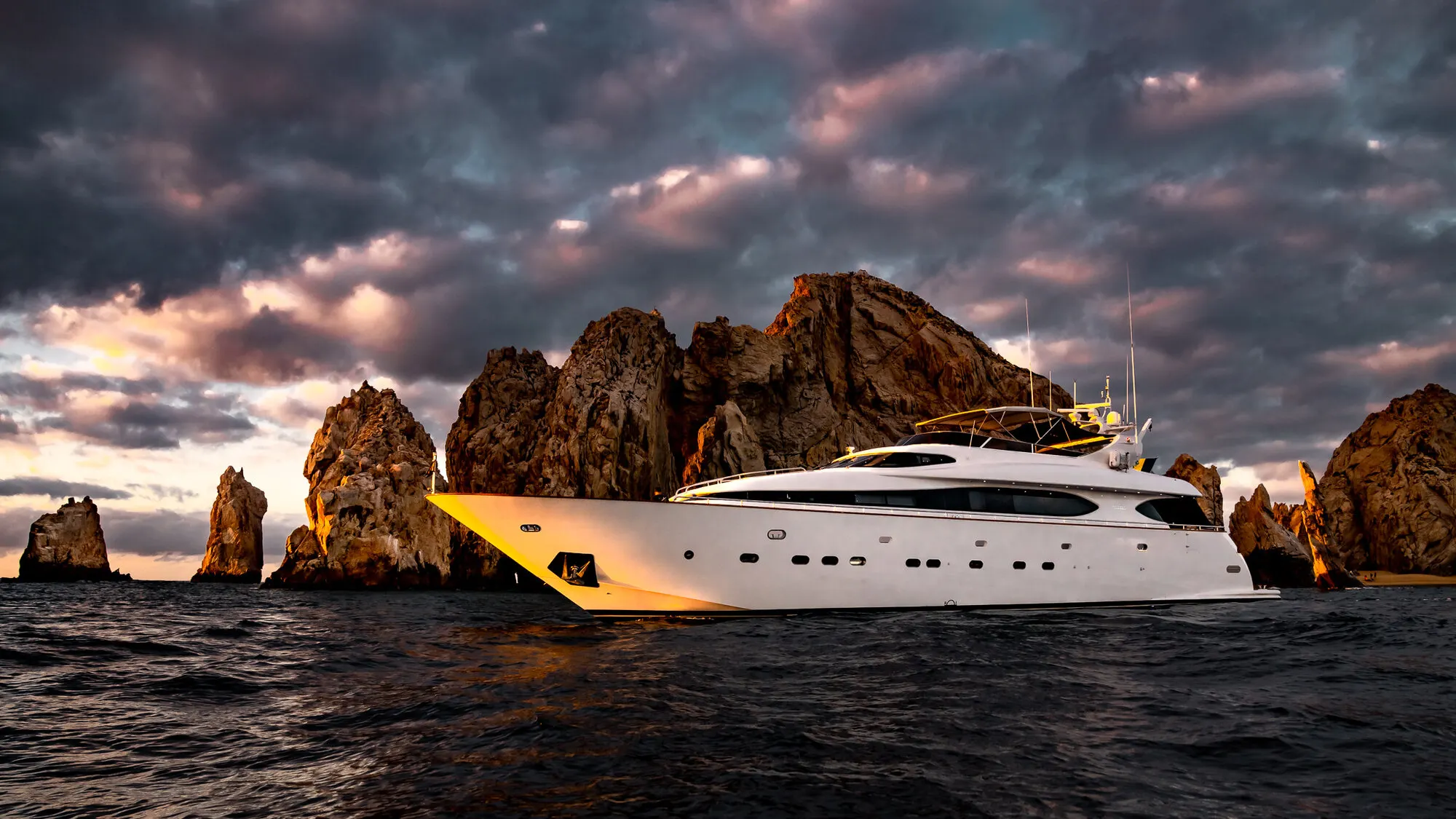 Bow to stern with the rocks behind and the sky burning off