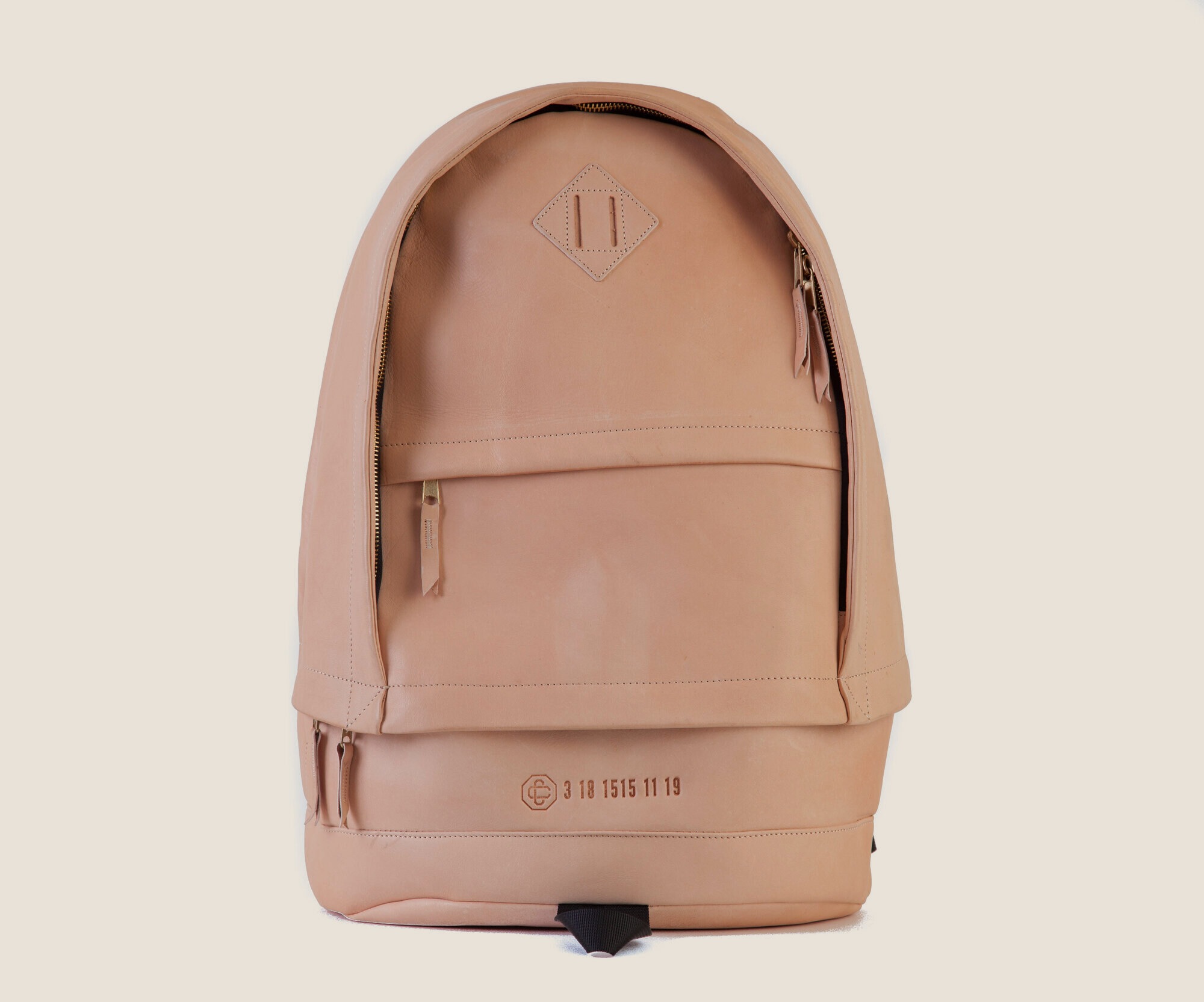 Tan full grain leather backpack with brass hardware
